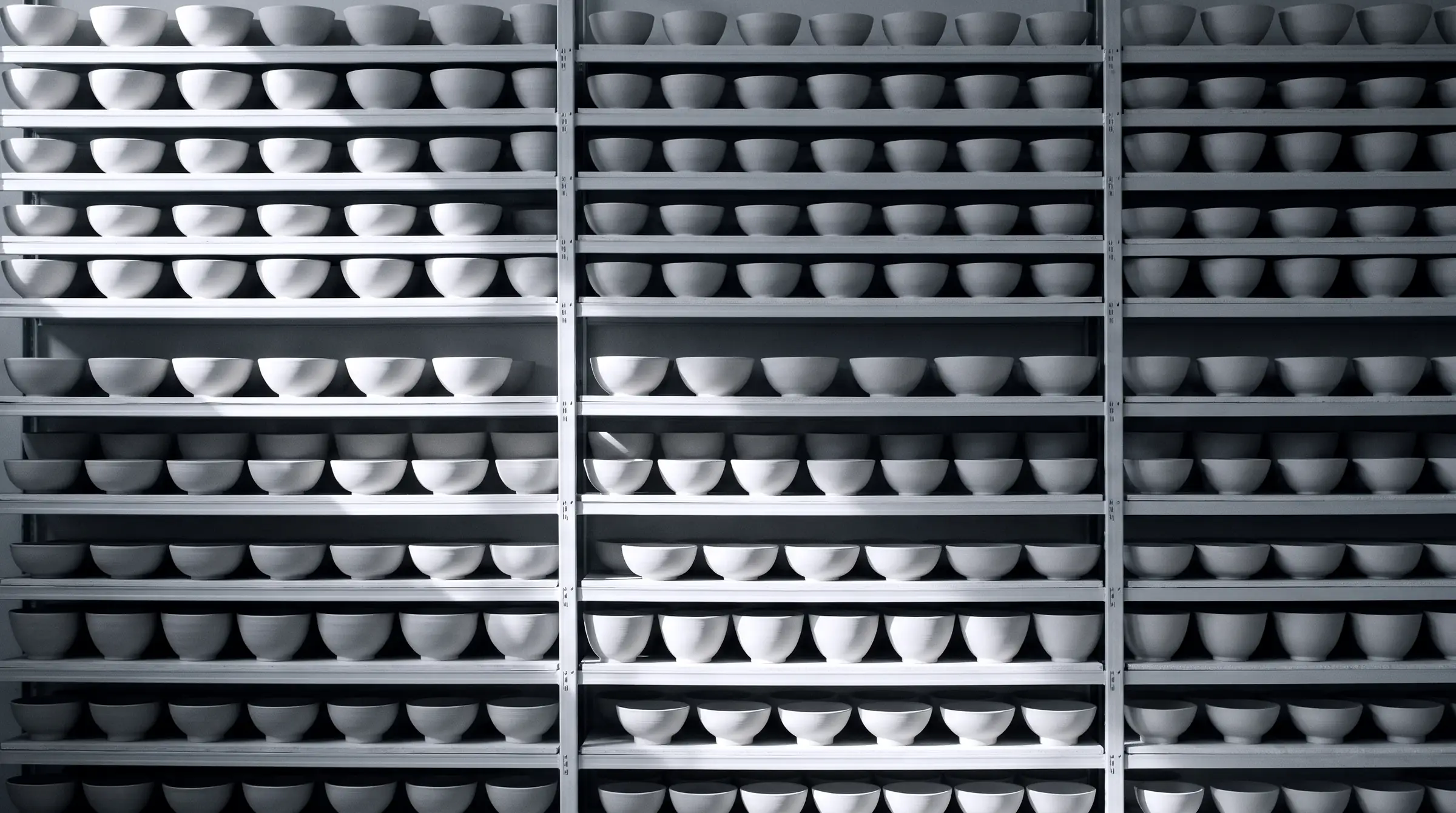A wall of shelves packed with identical bowls